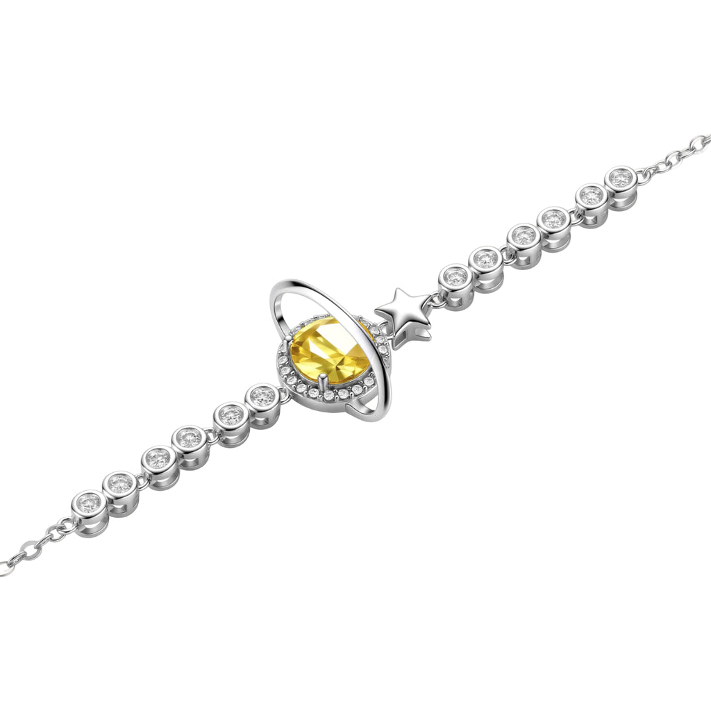 Sterling silver bracelet with yellow moissanite centerpiece in oval setting, crystal chain, and star charm on white background.