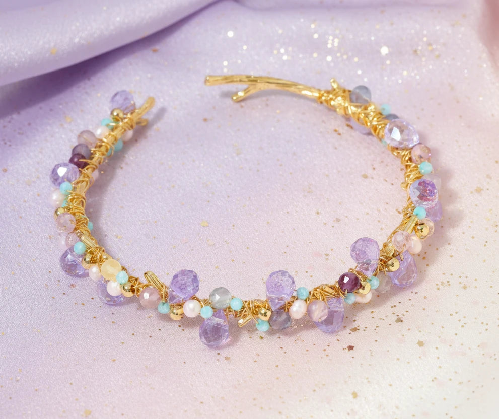 Gold-plated adjustable cuff bracelet with clustered lavender fluorite, turquoise beads, and freshwater pearls on white background.